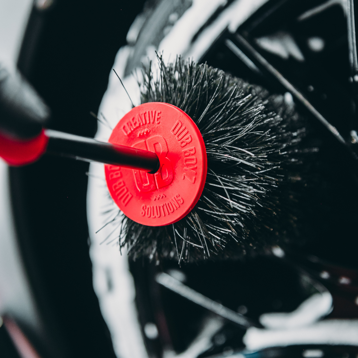 Flexible wheel hole brush reaching deep rim openings