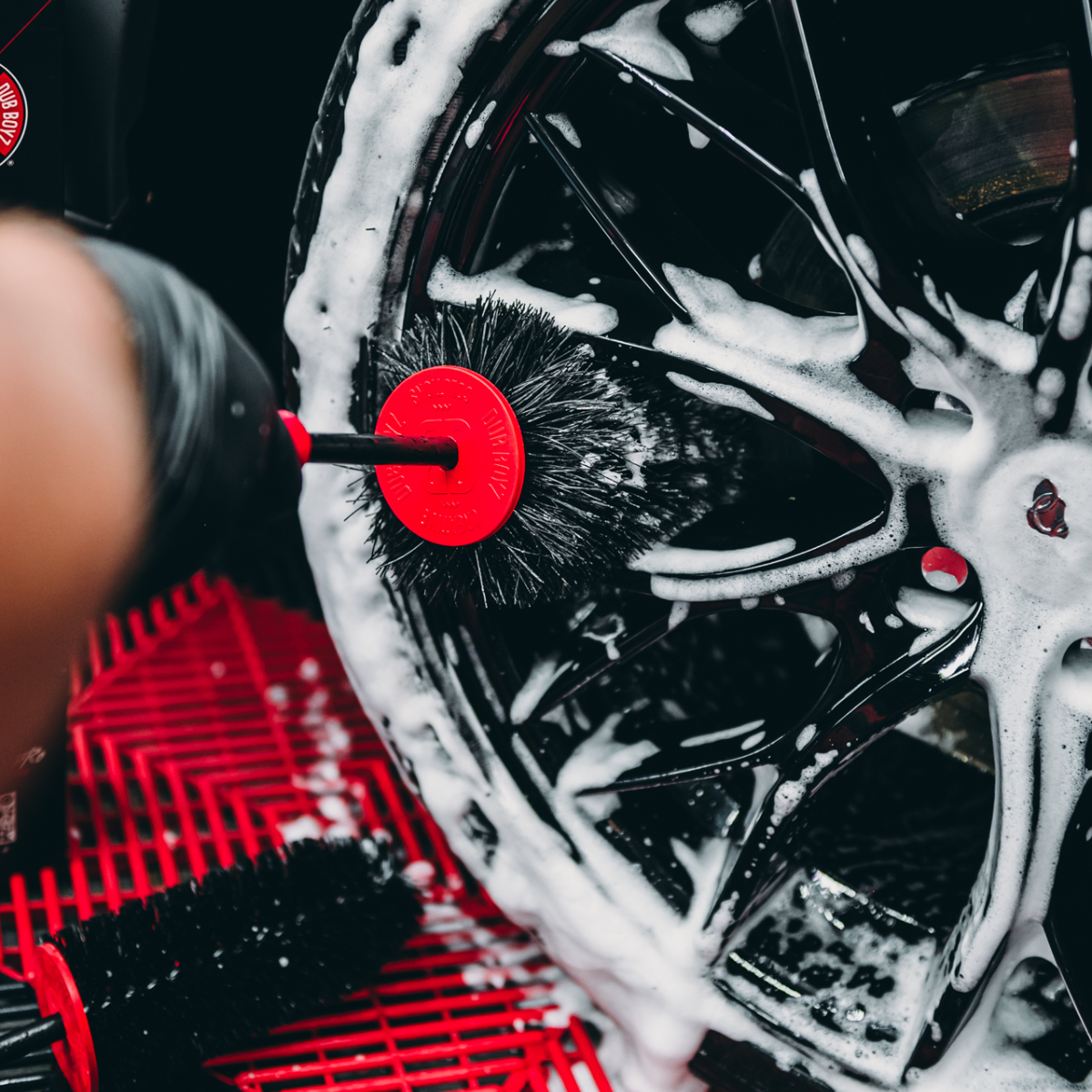 Wheel hole cleaning brush used on rim to remove brake dust